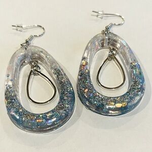 Handmade resin earrings. Silver and light blue with stainless steel charm.